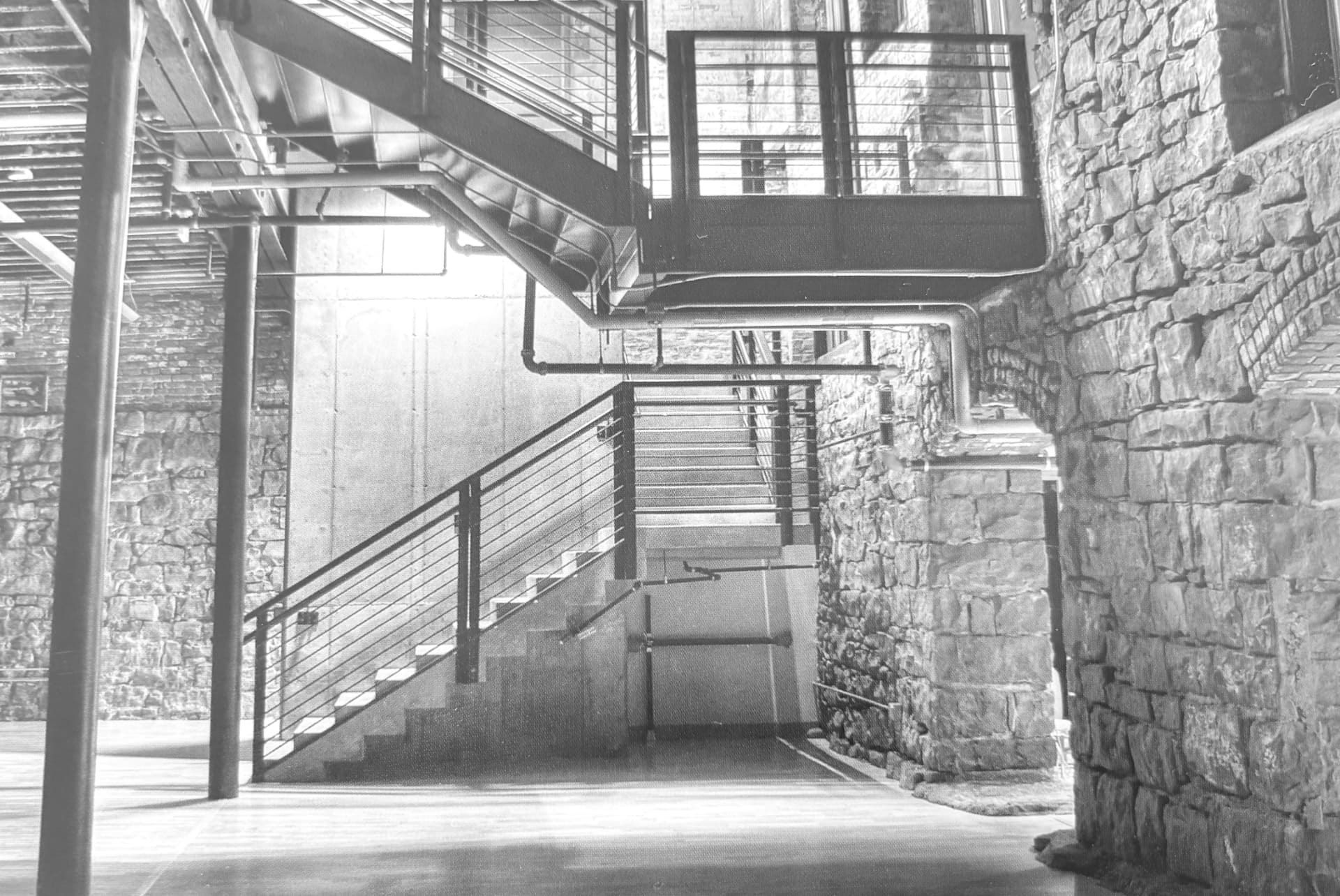 Historic interior staircase and stone masonry from a Frank Audino Construction project