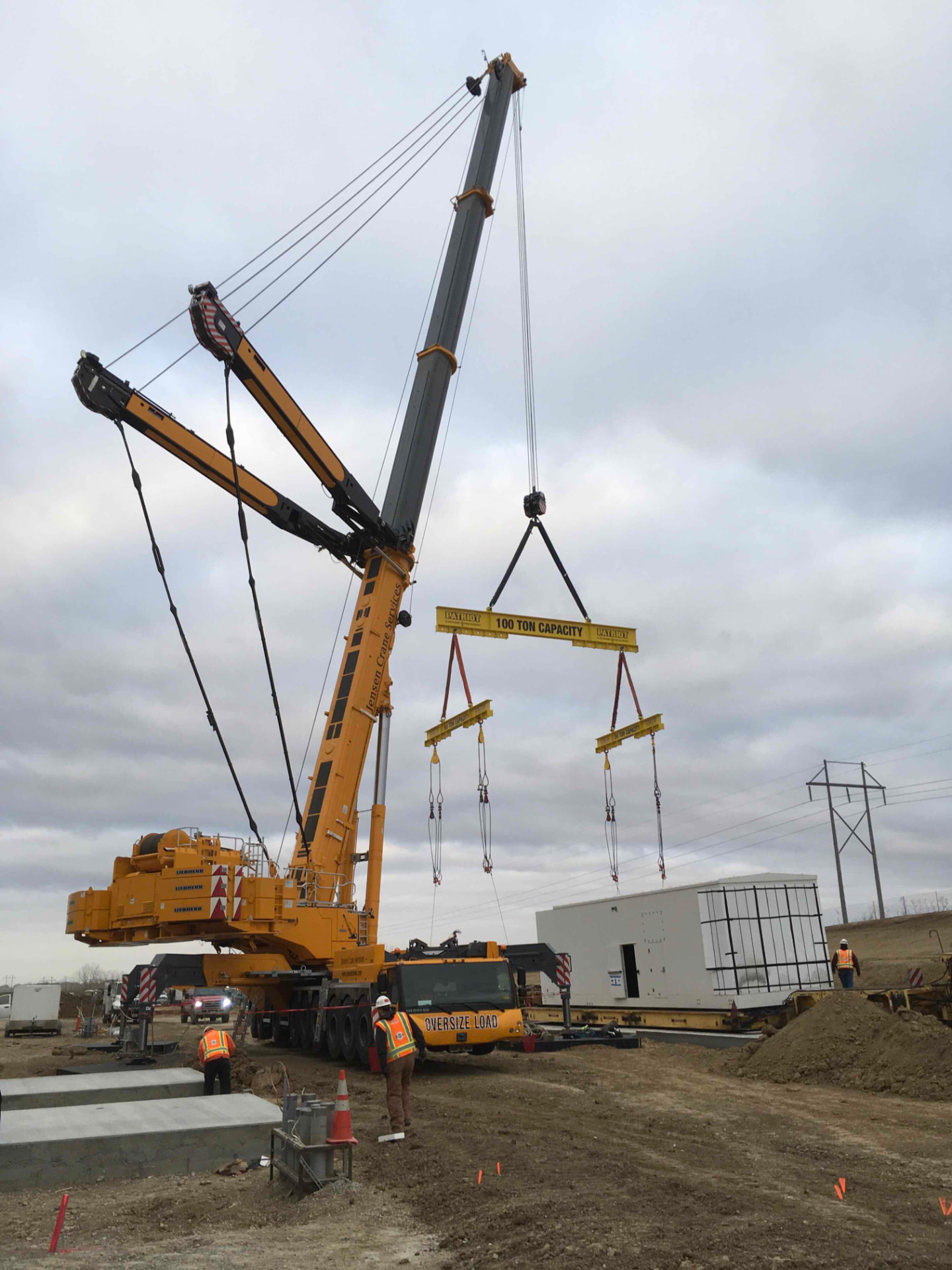 Mobile crane setting a modular building on a commercial construction site